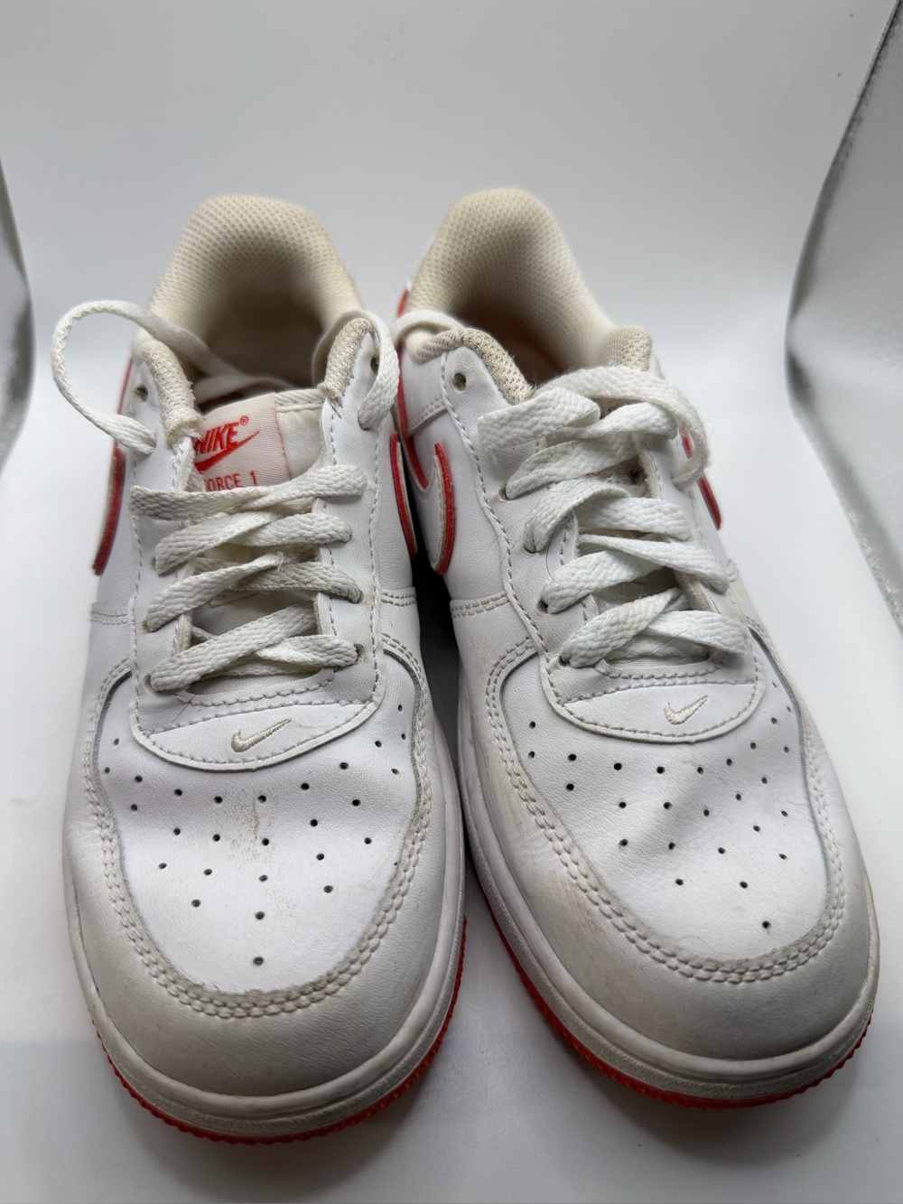 Nike White Sneakers with Red Swoosh Accents